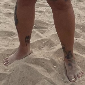 Beach tattooed feet