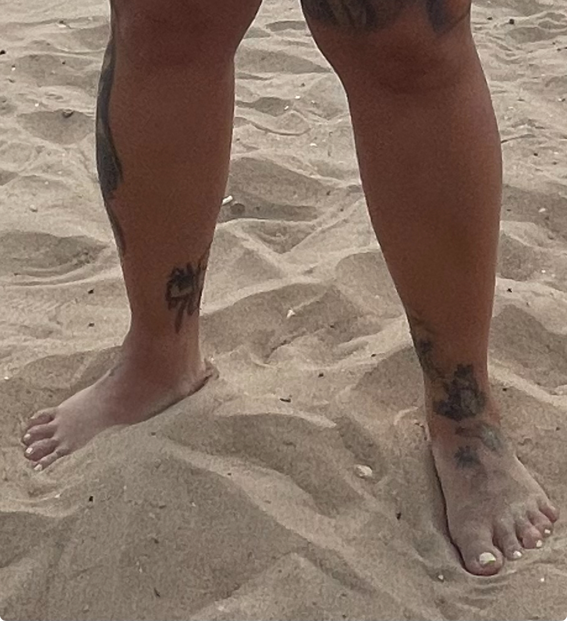 Beach tattooed feet